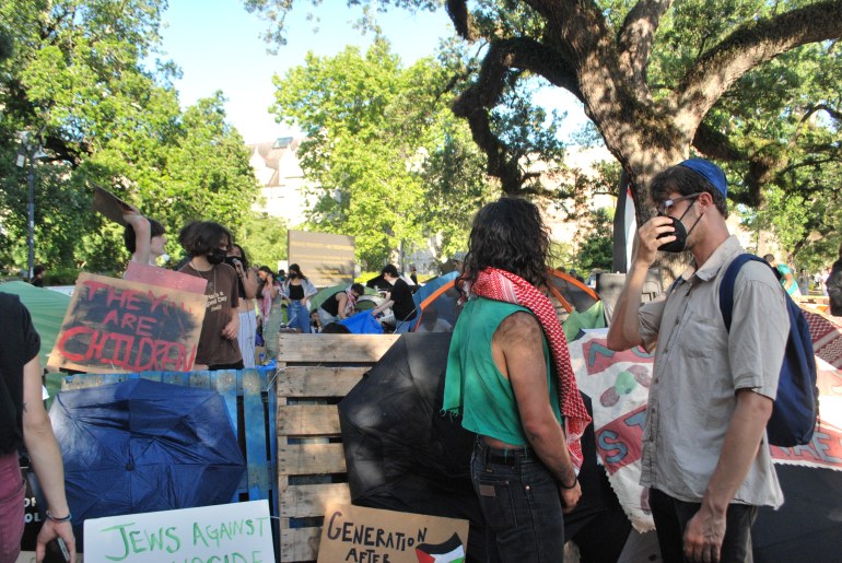 Two protesters, one wearing a yamulke, talk near the barricades of Tulane University's pro-Palestine encampment on April 30